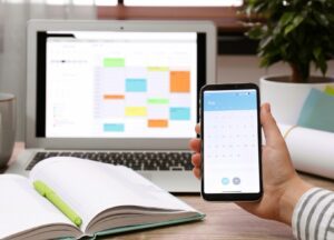Smartphone in front of the laptop and calendar